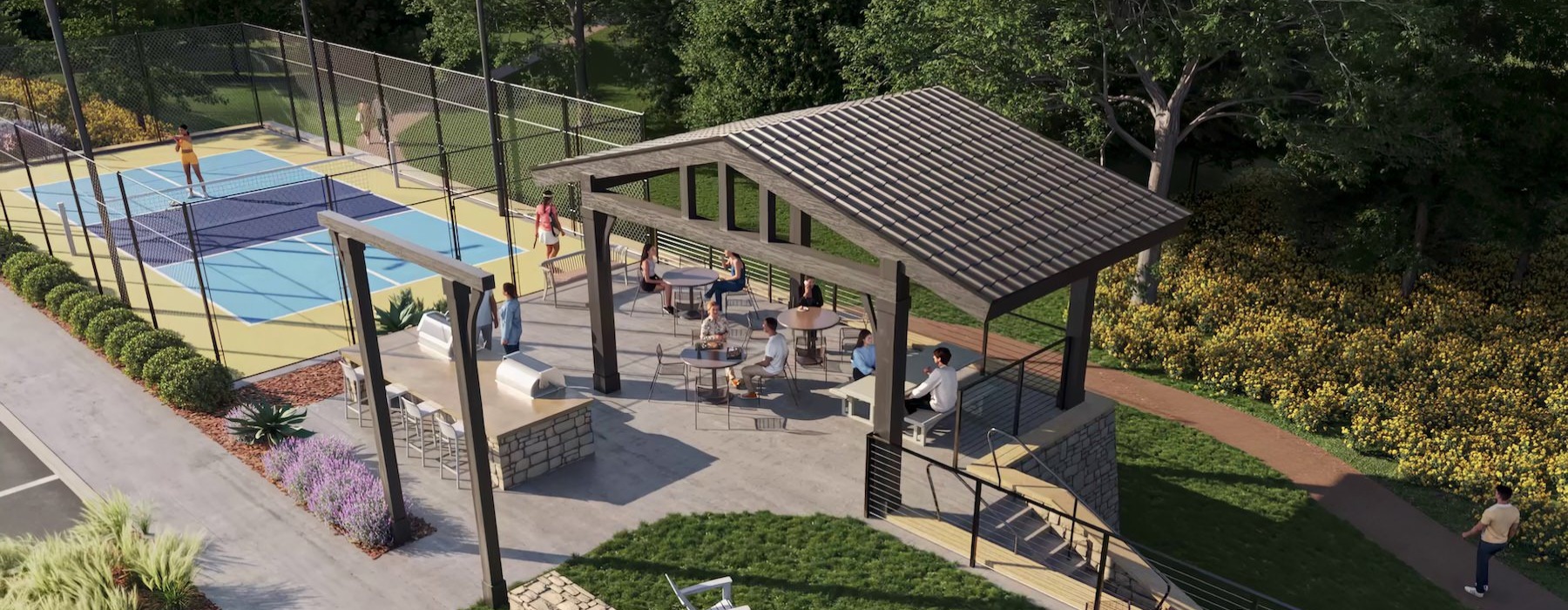 an outdoor area with seating grills and a pickleball court